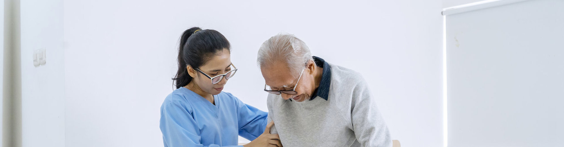 caregiver assisting to her patient to walk