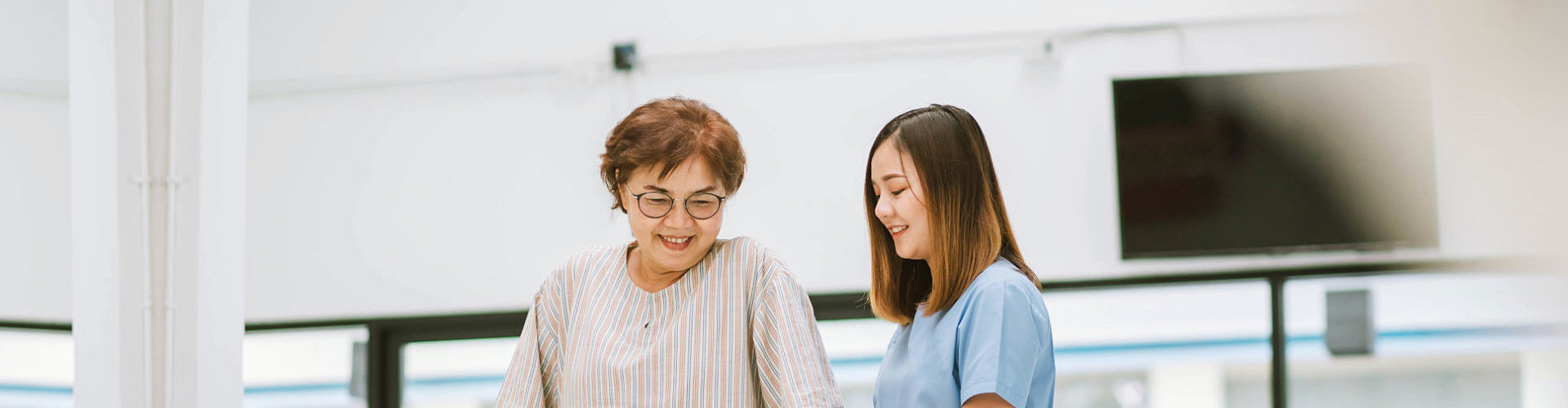 caregiver assisting to her patient to stand